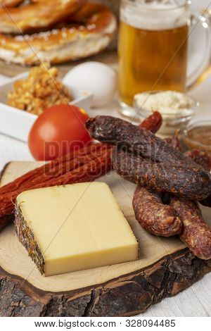 Closeup Of German Sausages With Cheese And Beer
