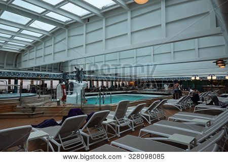 Victoria/canada-9/13/19: A Cruise Ship Indoor Pool And Hot Tub With Ornamental Penguins.