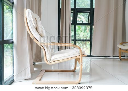 Wooden Armchair Sofa In Modern Room With Curtain On Glass Wondow