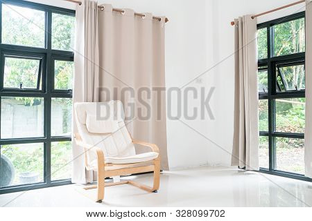 Wooden Armchair Sofa In Modern Room With Curtain On Glass Wondow