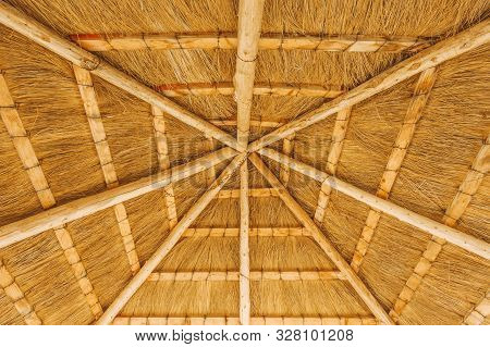 Close Up Shot Of The Inside Of A Thatched Reet Roof With Cross Beam Enforcements. Use For Background