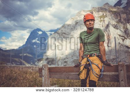 Young man climbing on a rock in Swiss Alps - via ferrata/klettersteig