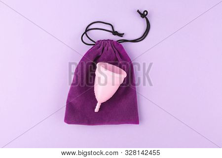 Menstrual Cup And Elegant Soft Case On Pink Background. Flatlay, Top View. Copy Space.
