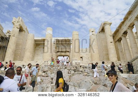 Crowd Of Tourists Clambering Around Ancient Structures Of The Acropolis