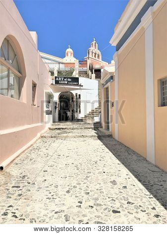 Santorini, Greece - 8/4/2019 -  Path Leading An Art Gallary And Churches In The Town Of Fira In Sant