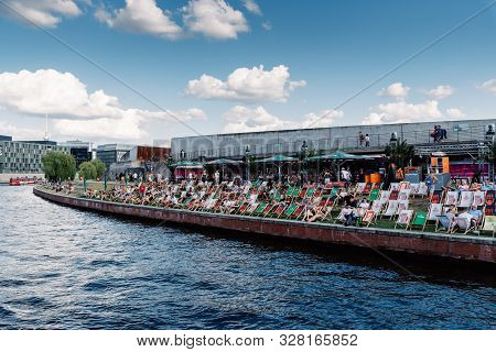 Berlin, Germany - July 27, 2019: People Enjoying At Open Bar In Spreebogen Park The Riverside Of Spr