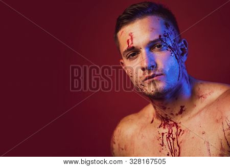 Bloody Make Up. Blood Lust. Piece Of Meat. Strong Man Wearing Butcher Apron With Blood Stains