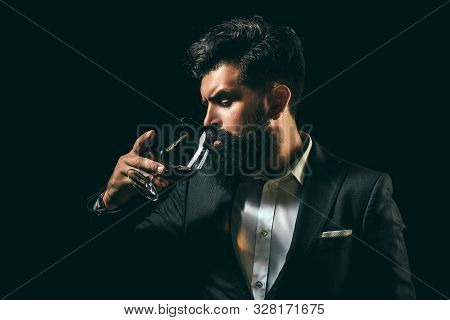 Cheerful Bearded Man Is Drinking Expensive Cognac. Old Traditional Whiskey Drink - Gentlemen Beverag