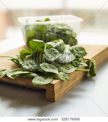 Baby Spinach Leaf On The Kitchen Wooden Board