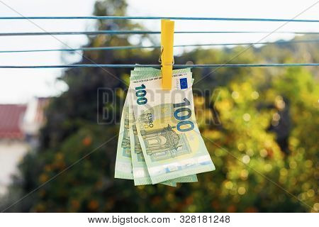 Euro Banknotes Hanging With Clothespin On Clothesline. Money Laundering Business Concept. Abstract C