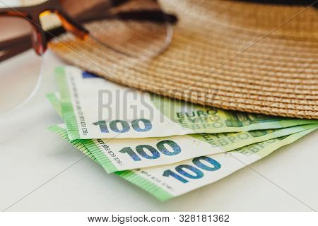 Sun Hat With Sunglasses And 100 Hundredth Euro Banknotes. Money Or Vacation Concept