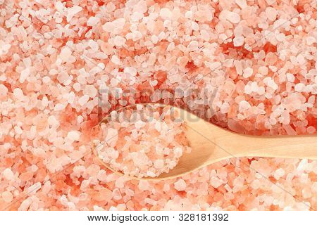 Close Up Top View Of Himalayan Pink Salt In Wooden Spoon.