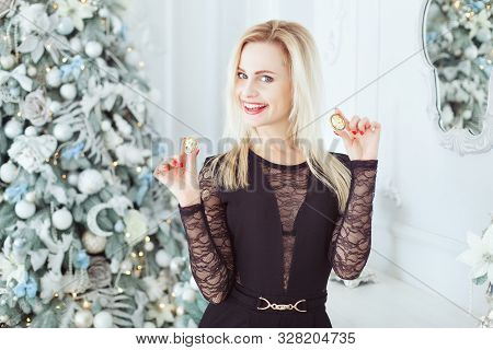 Portrait Of A Cute Blonde Woman With Bitcoins Near A Christmas Tree.