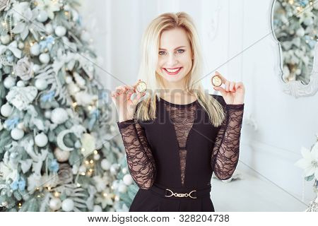Portrait Of A Cute Blonde Woman With Bitcoins In Hands Near A Christmas Tree. She Is Laughing.