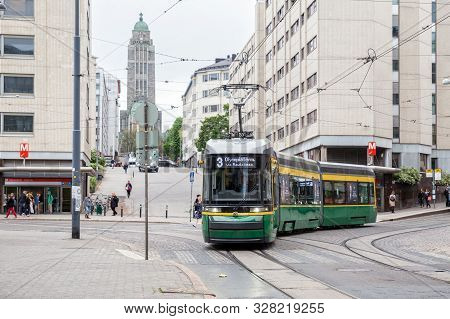 Helsinki, Finland - May 23, 2019: New Green Tram Skoda On Helsinki Street Turns Against The Backdrop
