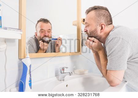 Bored Guy Brushing His Teeth In Bathroom