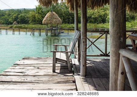 Lake Dock With Chair At A Sunny Day, El Remate, Guatemala