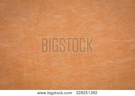 background and texture of ginger yellow Korean hanji paper handmade from inner bark of the mulberry tree