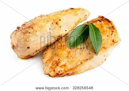 Two Whole Pan Roasted Chicken Breasts With Fresh Bay Leaf Garnish Isolated On White.