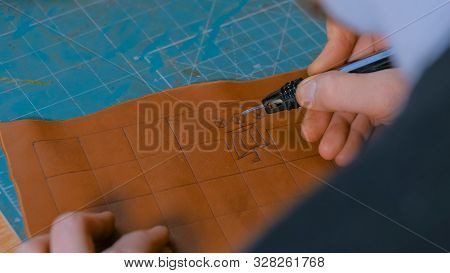 Professional Male Skinner, Tanner Making Decorative Details On Leather Playing Field For Strategy Bo