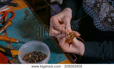 Professional Male Skinner, Tanner Working With Genuine Leather Belt At Workshop, Studio. Handmade An