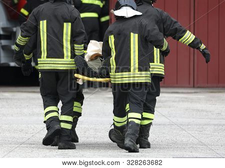 Four Firefighters Carrying Injured After The Road Accident