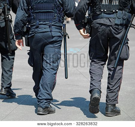 Cops With Riot Gear And Baton Or Trucheon And Guns