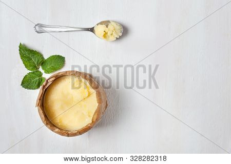 Homemade Ghee In A Jar, Wrapped In Parchment Paper With A Green Leaf. Ayurveda