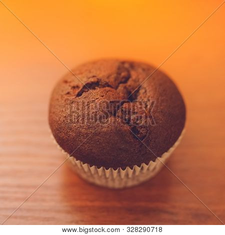 Chocolate Muffins On The Brown Wooden Table.