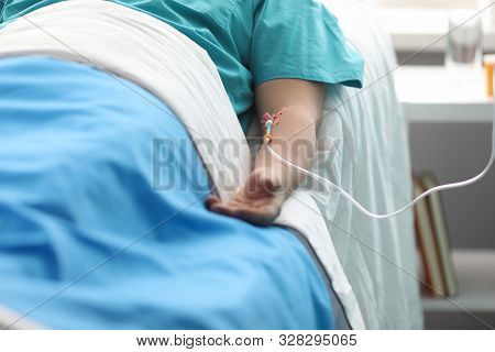 Fight For Life Concept. Hand Of A Young Man With A Dropper In Ward Of Medical Hospital. Lies After C