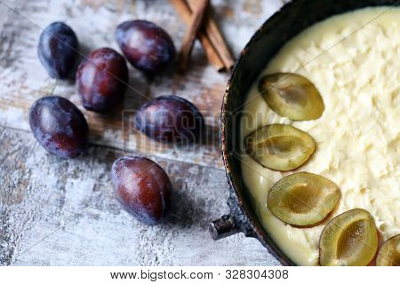 Making Plum Pie With Sugar And Cinnamon. American Plum Pie.