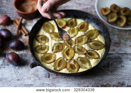 Making Plum Pie With Sugar And Cinnamon. American Plum Pie.