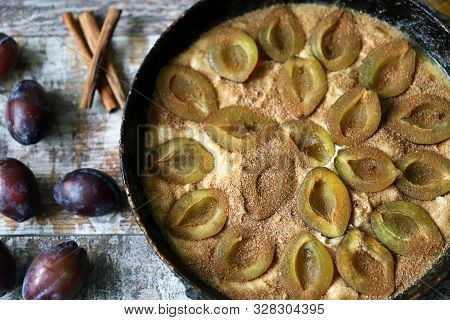 Making Plum Pie With Sugar And Cinnamon. American Plum Pie.