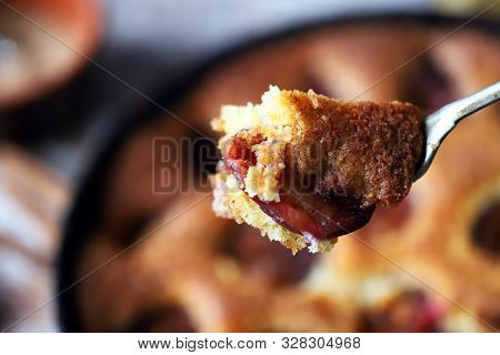 Selective Focus. Slice Of Plum Pie On A Fork. Homemade American Plum Pie. Macro.
