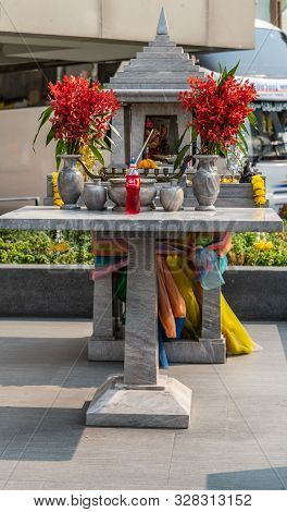 Bangkok City, Thailand - March 17, 2019: Public Small Gray Marble Buddhist Shrine Has Red Flower Bou