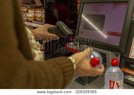 Monte Carlo, Monaco, 10/05/2019: Self-checkout Counter In A Supermarket. A Young Man Scans Purchases
