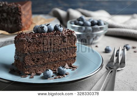 Delicious Fresh Chocolate Cake Served With Blueberries On Grey Table