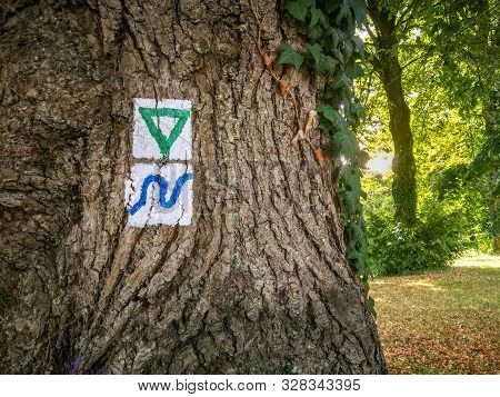 Typical German Painted Trail Markers On A Tree Showing The Direction Of Hiking Trails
