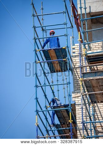 Two African workers climbed on the scaffolding on a construction site in Botswana