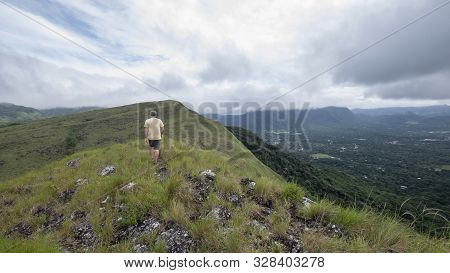 Male Hiker Walking Along The Ridge On Top Of India Dormida Mountain In El Valle De Aton, Panama