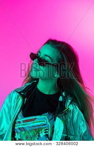 Young Stylish Girl Dancing In The Studio On A Colored Neon Background. Music Poster Design.