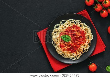 ?lassic Italian Spaghetti Pasta With Tomato Sauce And Basil On Plate On Dark Table. View From Above,