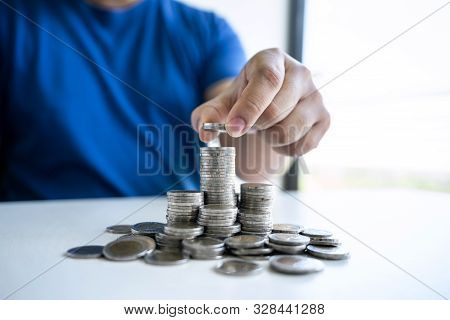 Man Putting Coins To Planning Growing Saving To Strategy With Piggy Bank For Future Plan Fund Of Tra
