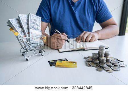Man Writing Report To Planning Growing Saving To Strategy With Money Box For Future Plan Fund Of Tra