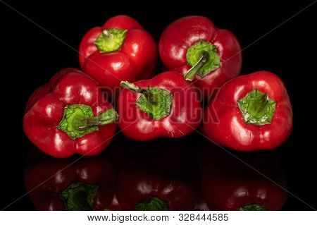 Group Of Five Whole Sweet Red Bell Pepper Isolated On Black Glass