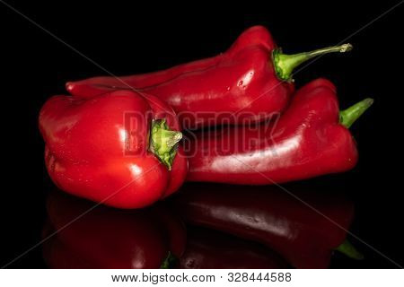Group Of Three Whole Sweet Red Bell Pepper Isolated On Black Glass