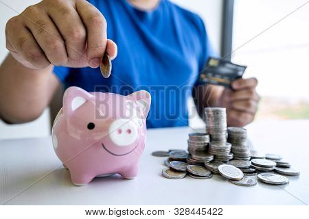 Man Putting Coins To Planning Growing Saving To Strategy With Piggy Bank For Future Plan Fund Of Tra