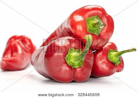 Group Of Four Whole Sweet Red Bell Pepper Isolated On White Background