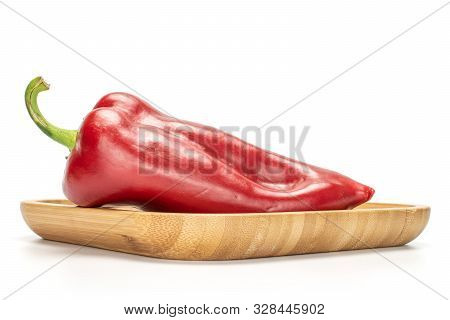 One Whole Sweet Red Bell Pepper On Wooden Square Plate Isolated On White Background
