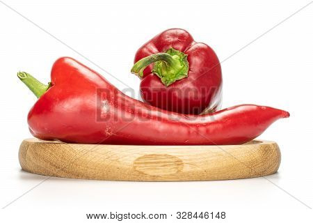 Group Of Two Whole Sweet Red Bell Pepper On Bamboo Plate Isolated On White Background